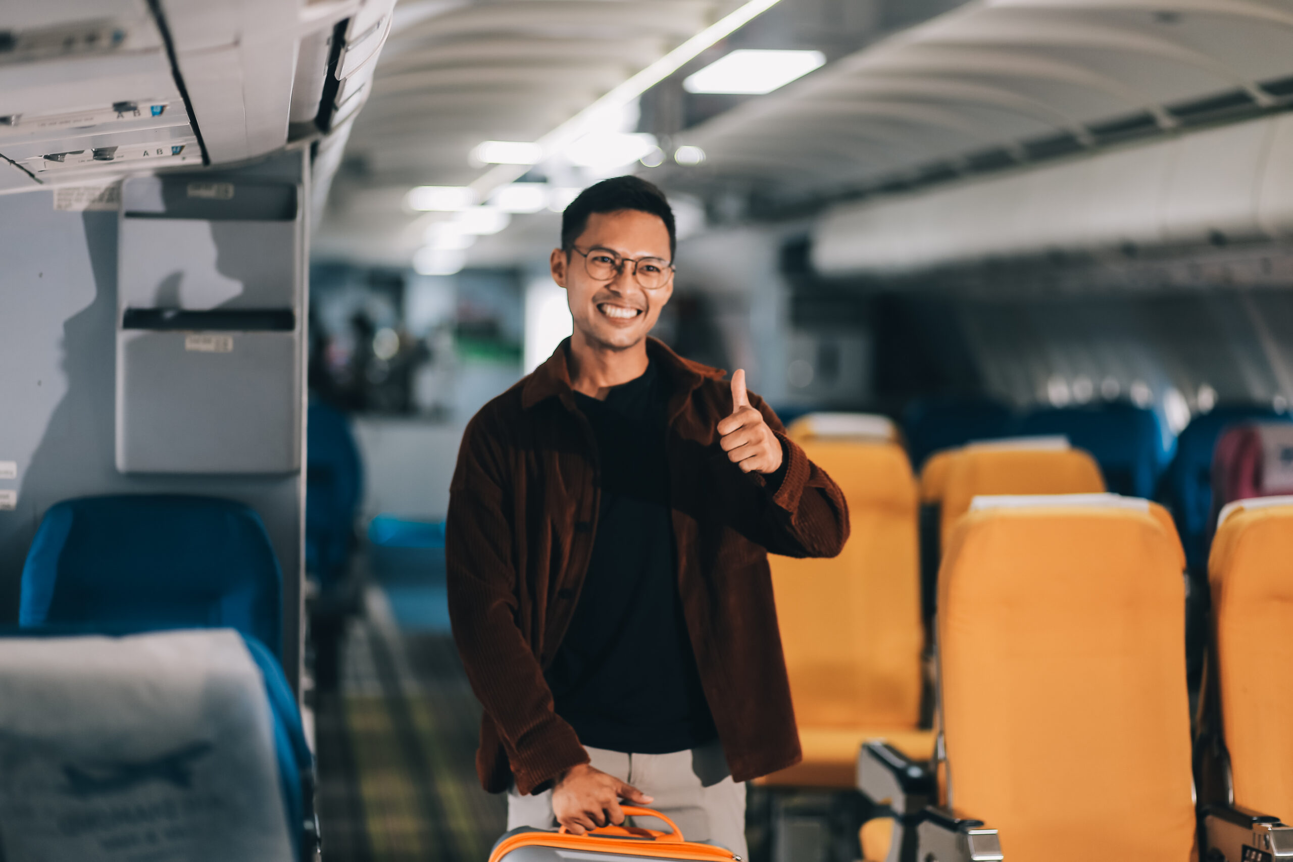 A smiling team member gives a thumbs-up on a bus, showing Transpo’s supportive culture.